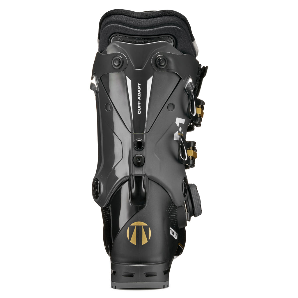 MACHBOAHV75-Black Tecnica ski boot with gold accents on a white background
