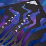GammaAPX- Close-up of a snowboard deck with purple and blue flame design and brand logo.
