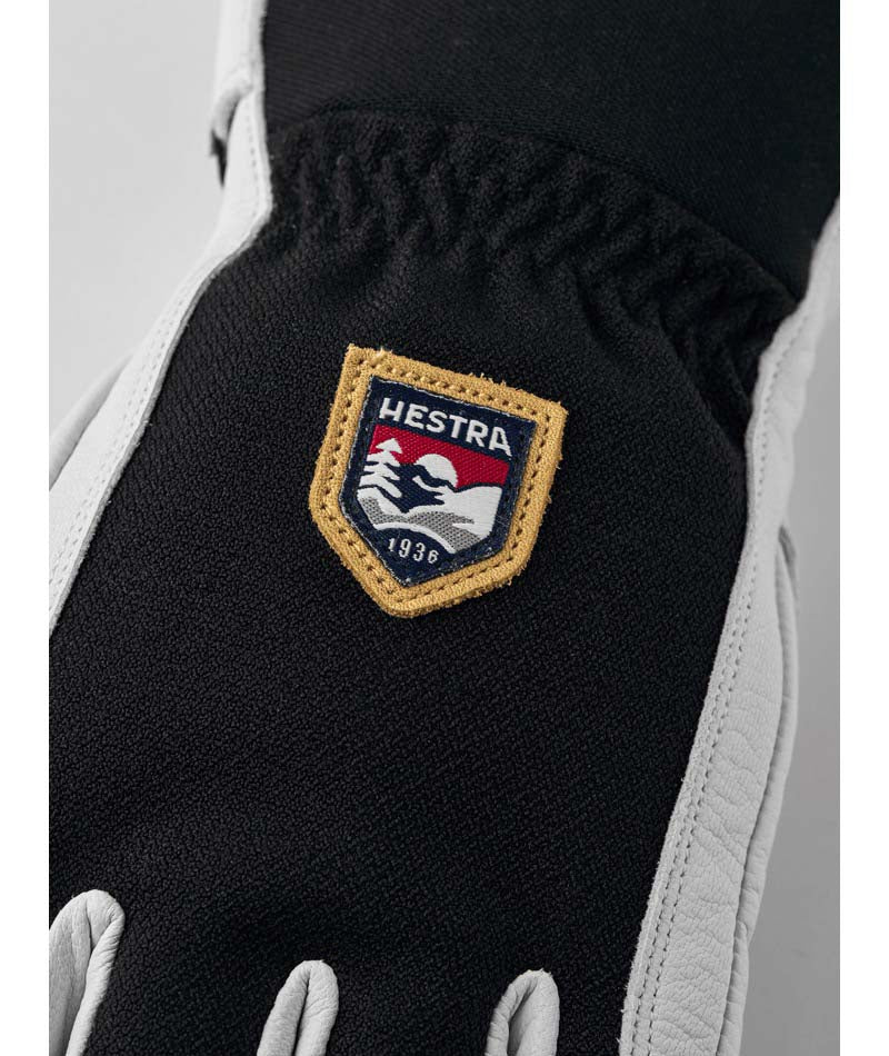 ArmyLeatherPatrol-Pair of black and white gloves with a logo on a white background