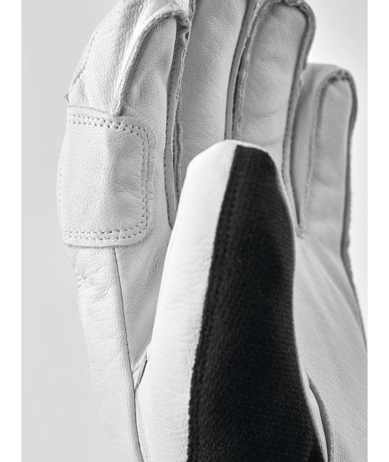 ArmyLeatherPatrol-Pair of black and white gloves with a logo on a white background