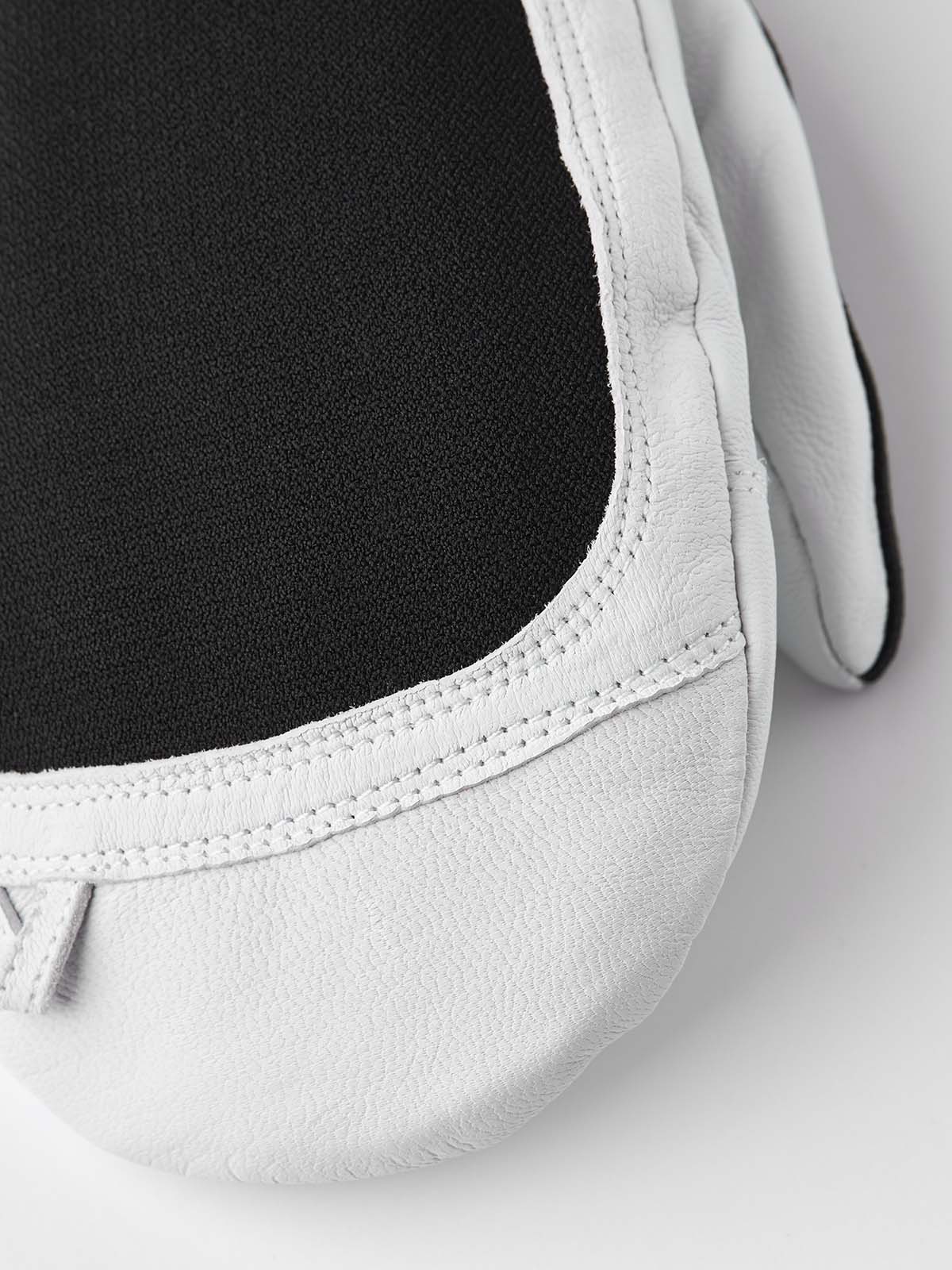 ArmyLeatherPatrolMitt-Pair of white and black mittens with a visible brand logo on a white background