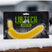 BananaWax- Lib Tech banana wax packaging on a snowy surface with a blurred background
