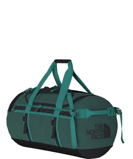 BaseCampDuffel_M-Green duffel bag with 'The North Face' logo on a white background