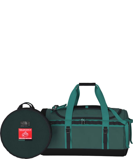 BaseCampDuffel_M- Green duffel bag with a circular black cover on a white background
