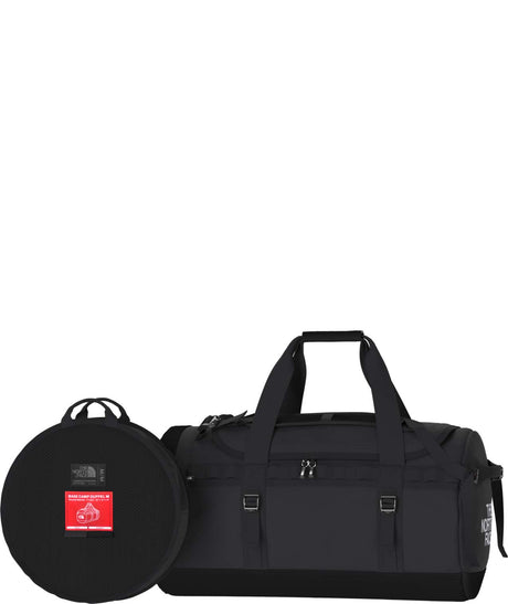 BaseCampDuffel_M-Black duffel bag and round travel case on a white background