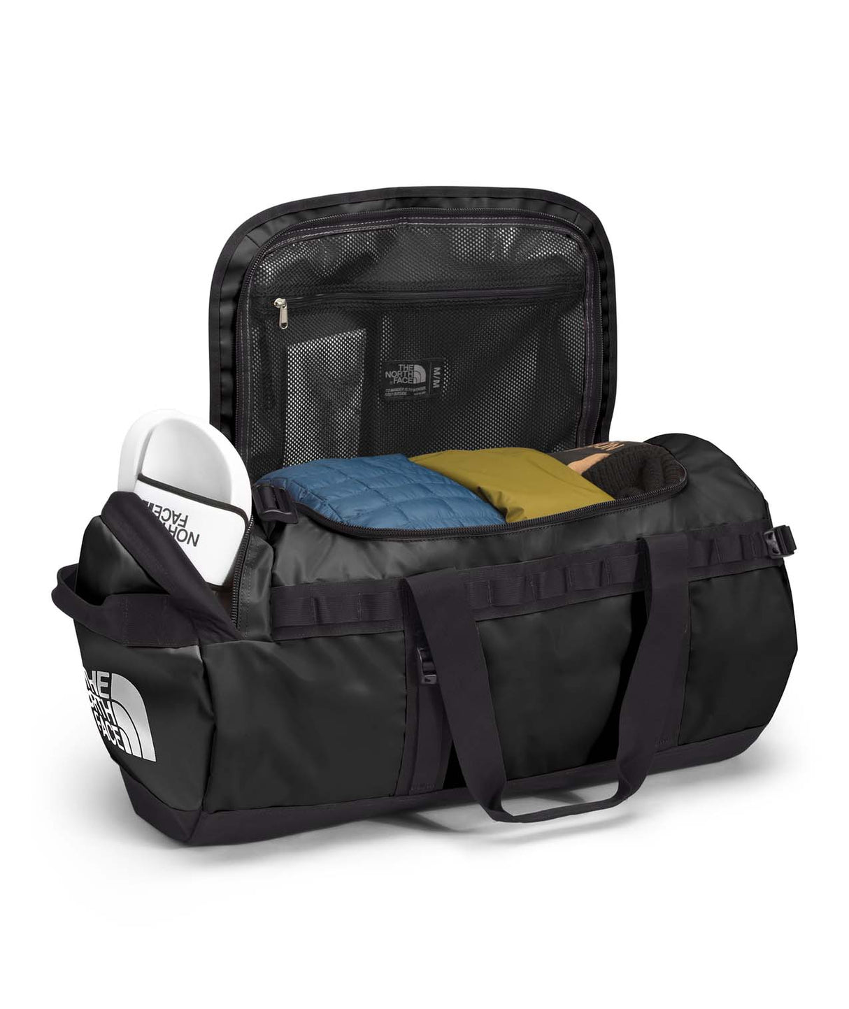 BaseCampDuffel_M-Black duffel bag with items inside on a white background