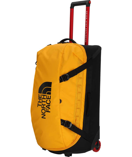 BaseCampRollingThunder_28-Yellow rolling duffel bag with black accents and The North Face logo on a white background