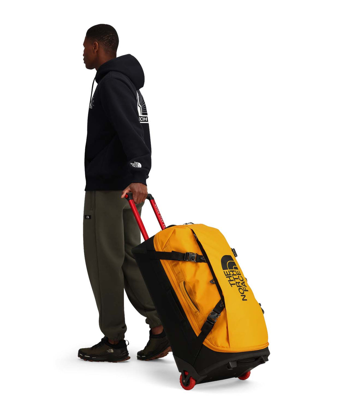 BaseCampRollingThunder_28-Yellow rolling duffel bag with black accents and The North Face logo on a white background