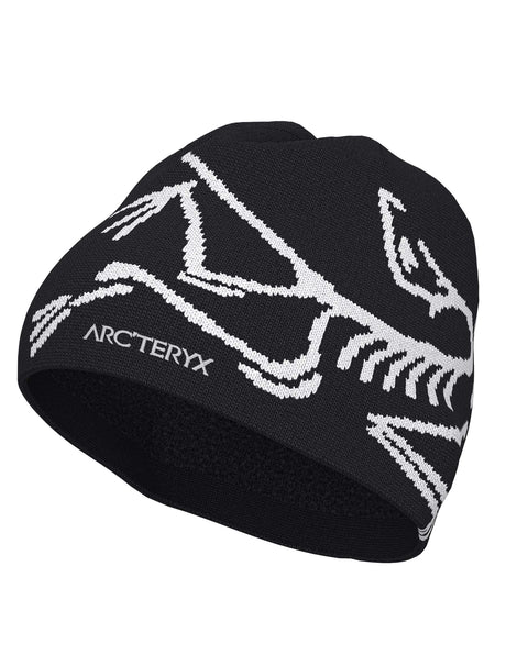 BirdHeadToque-A black knit beanie hat featuring a white knit Arc'teryx bird logo and the brand name 'ARC'TERYX' on the side, with a black fleece lining visible at the opening.