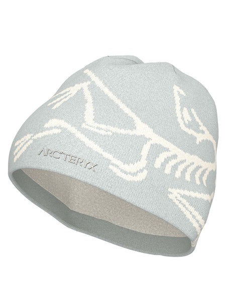 BirdHeadToque-A light grey knit beanie hat featuring a white knit Arc'teryx bird logo and the brand name 'ARC'TERYX' on the side, with a white fleece lining visible at the opening.
