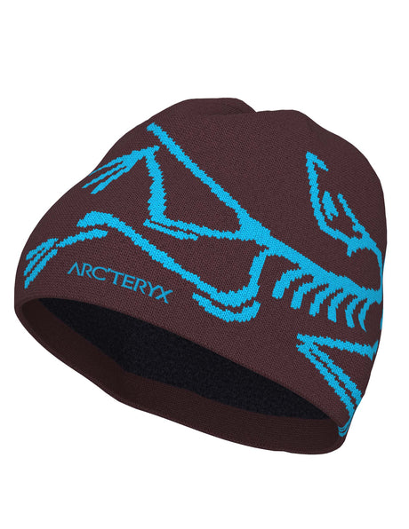 BirdHeadToque-A burgundy knit beanie hat featuring a light blue knit Arc'teryx bird logo and the brand name 'ARC'TERYX' on the side, with a black fleece lining visible at the opening.
