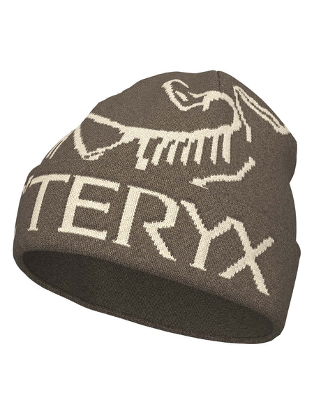 BirdWordToque-A brown knit beanie hat featuring a light beige knit Arc'teryx bird logo and the brand name 'ARC'TERYX' on the front cuff, with a brown fleece lining visible at the opening.