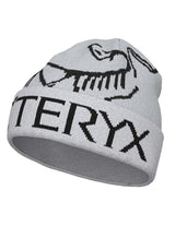 BirdWordToque-A light gray knit beanie hat featuring a black knit Arc'teryx bird logo and the brand name 'ARC'TERYX' across the front cuff.