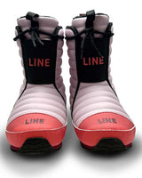 Bootie2- A single boot from the brand LINE, featuring a light pink quilted upper, a coral-pink toe and heel, and a black vertical strap with the brand name printed in coral-red.