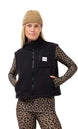 BoxySherpaVest-Person wearing a black vest with a brand logo, leopard print sleeves, pants, and beanie on a white background