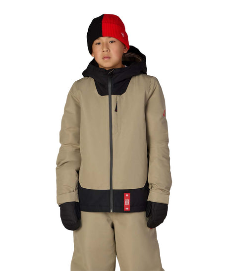 BoysGatewayInsulatedJacket-Person wearing a beige snowsuit with black accents and a red and black beanie on a white background
