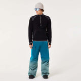 ButterTechFleece-Person wearing black fleece and blue pants with a white background