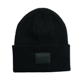 CoalCashmereKnitCuffBeanie-Black beanie with a patch on a white background