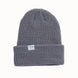 CoalTheStanleyBeanie-A dark gray ribbed knit beanie hat with a folded cuff, featuring a small white rectangular label on the front that reads 'coal'. The beanie is photographed against a clean, solid off-white background.