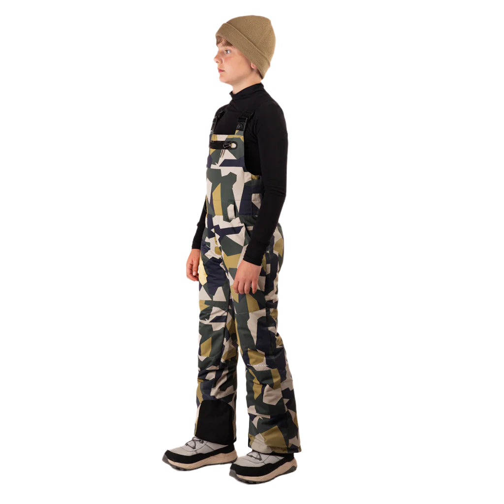 CooperBib-Child wearing camouflage bib overalls on a white background