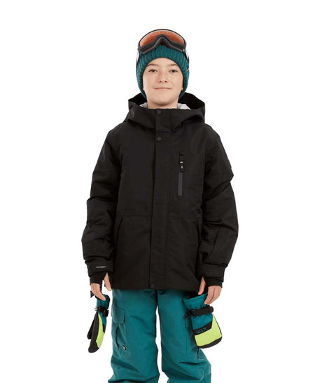 CosmicJacket-A child wearing a black snowboard jacket, teal snow pants, a teal knit beanie with ski goggles on top, and holding black and neon yellow gloves, photographed against a plain white background.