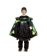 CosmicJacket-A person wearing a green beanie and goggles holds up a black snowboard jacket with bright green and yellow camouflage-style accents, shown against a plain white background.