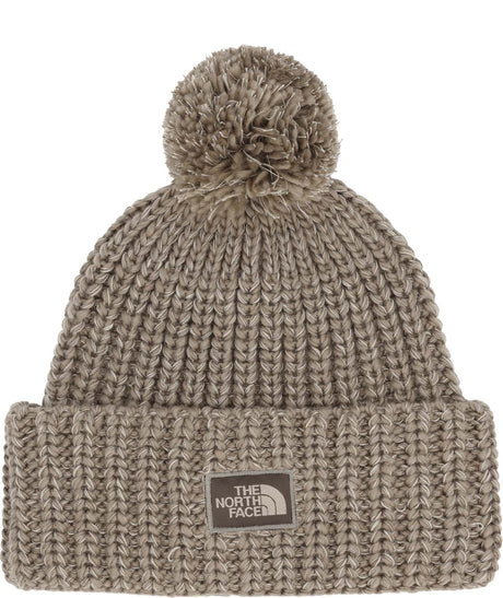 CozyChunkyCabinBeanie-Beige knit beanie with pom-pom and The North Face logo on a white background