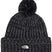 CozyChunkyCabinBeanie-Black knit beanie with pom-pom and The North Face logo on a white background