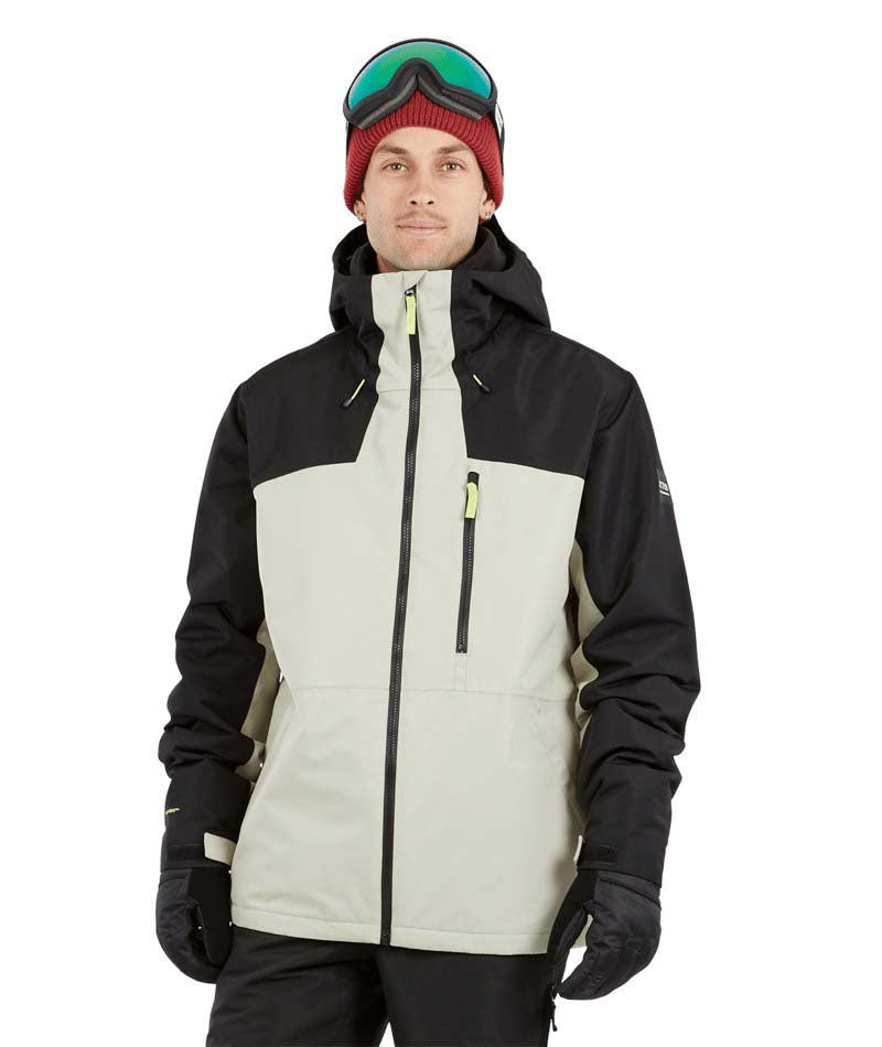DescentJacket-A man wearing a black and off-white ski jacket with black gloves, a red knit beanie, and ski goggles, photographed against a solid white background.