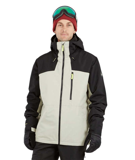 DescentJacket-A man wearing a black and off-white ski jacket with black gloves, a red knit beanie, and ski goggles, photographed against a solid white background.