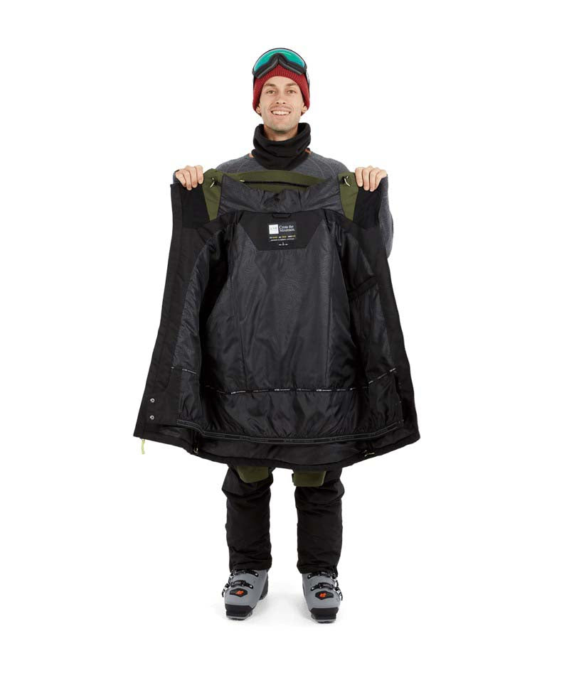 DescentJacket-A man wearing a colorblock snowboard jacket in olive green and black, paired with a red knit beanie, green-tinted ski goggles, and black gloves, against a plain white background.