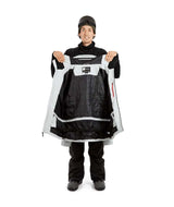 ExposureJacket-A man wearing a light gray ski jacket with black zippers, a dark beanie with goggles, and brown gloves, standing against a plain white background.