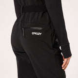 WTNPHarperSoftshellBib-Black ski jumpsuit with a belt on a light gray background