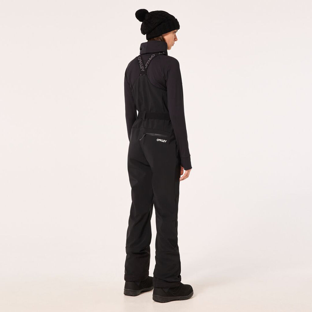 WTNPHarperSoftshellBib-Black ski jumpsuit with a belt on a light gray background