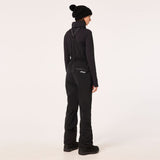 WTNPHarperSoftshellBib-Black ski jumpsuit with a belt on a light gray background