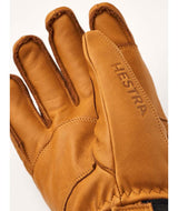 FallLine-Pair of brown leather gloves with black cuffs on a white background
