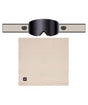 FoundationGogglePack-A pair of black ski goggles with a wide beige strap, shown above a matching beige neck gaiter. The goggles feature a dark tinted lens and a strap with a circular logo, while the neck gaiter has a small square logo in the lower left corner.