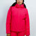 GaiaWomensInsulatedJacket-A woman modeling a bright pink ski jacket and matching ski pants, wearing a black beanie, dark goggles, and a black headband against a plain light gray studio background.
