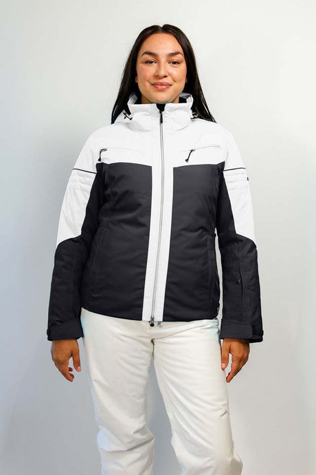 HelenaWomensInsulatedJacket-A woman modeling a colorblock ski jacket in white and black, paired with white ski pants, against a light gray studio background.