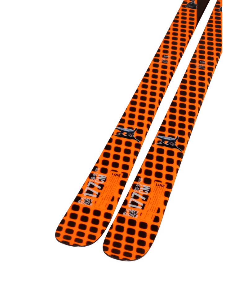 HoneyBadger- Orange and black skis with visible branding on a white background