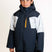 HydraBoysInsulatedJacket-A young boy wearing a dark navy and light gray color-blocked ski jacket with a bright yellow zipper, paired with matching dark pants, photographed against a clean white studio background.