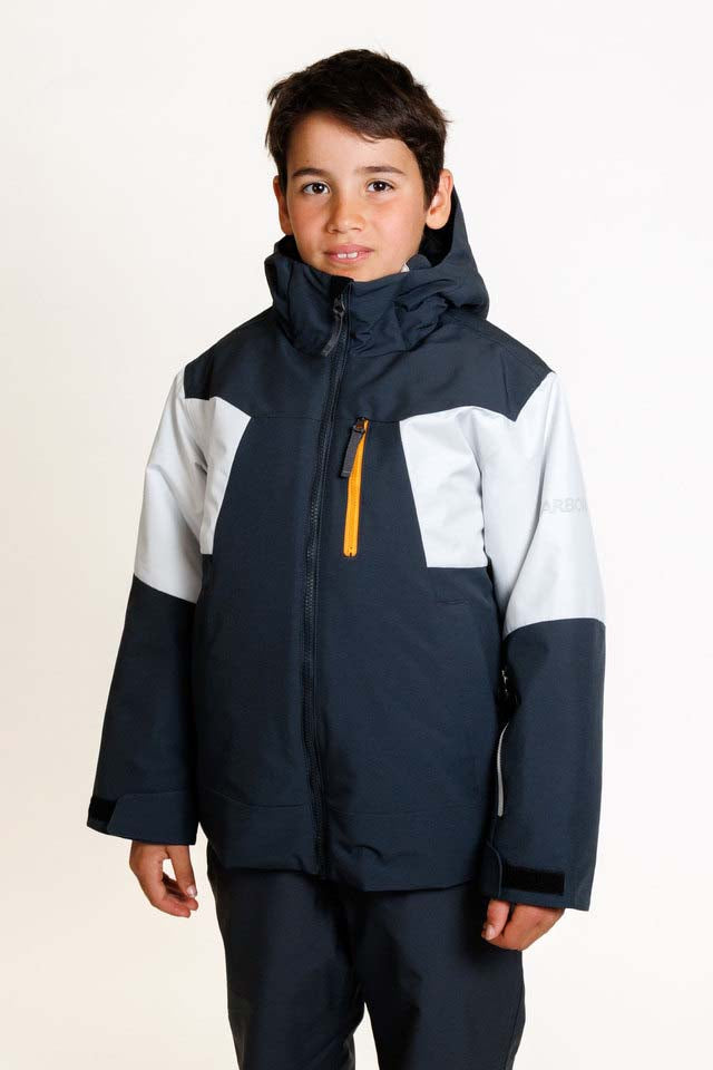 HydraBoysInsulatedJacket-A young boy wearing a dark navy and light gray color-blocked ski jacket with a bright yellow zipper, paired with matching dark pants, photographed against a clean white studio background.