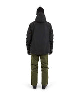 KnoxJacket-A man wearing a black snowboard jacket, black beanie with goggles, and gray gloves, standing against a solid white background.