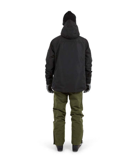 KnoxJacket-A man wearing a black snowboard jacket, black beanie with goggles, and gray gloves, standing against a solid white background.