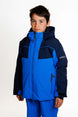 KrakenBoysInsulatedJacket-A young boy wearing a blue and navy Karbon ski jacket and matching blue ski pants, standing against a plain white studio background.