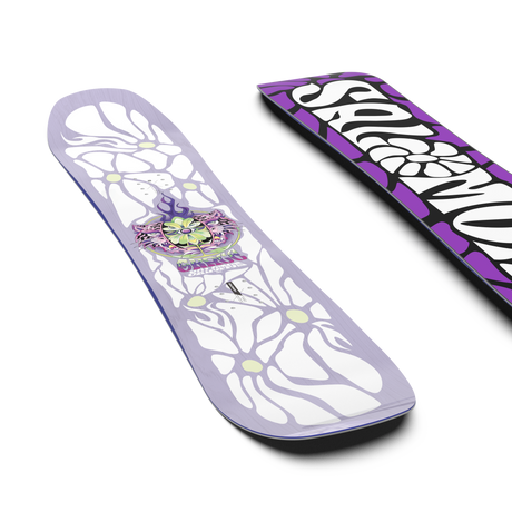 Grace- A kids' snowboard with a predominantly purple color and white detailing, featuring a floral and butterfly pattern, and the Salomon brand name.