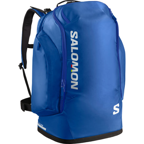 Go To Snow 50L-A blue Salomon boot bag with a 50L capacity, featuring a ventilated boot compartment and multiple accessory pockets. It has black padded backpack straps and the brand logo is visible.