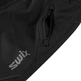 LillehammerKidsPants-Black athletic pants with zippered side pockets and a white SWIX logo on the left thigh, shown against a plain white background.