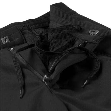 LillehammerKidsPants-Black athletic pants with zippered side pockets and a white SWIX logo on the left thigh, shown against a plain white background.