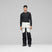 LofotenGore-TexProPant-Person wearing a black long-sleeve top and white pants with black accents on a gray background